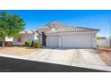 Single-story house with a two-car garage and landscaped front yard at 7074 Sea Orchard St, Las Vegas, NV 89131