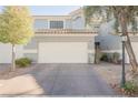 Front view of a two-story townhome with a white garage door at 2313 Pacific Creek St, Las Vegas, NV 89117