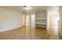 Living room with tiled flooring, white walls, and built-in shelving at 265 N Lamb Blvd # D, Las Vegas, NV 89110