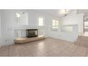 Living room with tile floors, fireplace, and high ceilings at 10792 Spruce Bough St, Las Vegas, NV 89183