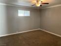 Spacious bedroom with neutral wall colors, carpet flooring, and ceiling fan at 612 Tam O Shanter, Las Vegas, NV 89109