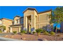 Two-story house with beige exterior, three-car garage, and landscaped yard at 6258 Windfresh Dr, Las Vegas, NV 89148