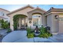 Landscaped front yard with an ornate gate and a tranquil fountain at 2721 Crystal Beach Dr, Las Vegas, NV 89128