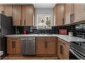 Modern kitchen with stainless steel sink and dishwasher, and light wood cabinets at 4621 Kathleen Ct, Las Vegas, NV 89110