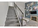 Modern staircase with gray carpeting and metal railing at 693 Harbor Mist Ave, Henderson, NV 89015