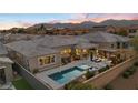 Aerial view of house, pool, and landscape with mountain views at 10010 Savannah Marie Ave, Las Vegas, NV 89149