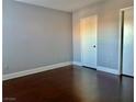 Simple bedroom with hardwood floors and a closet at 7255 W Sunset Rd # 2090, Las Vegas, NV 89113