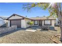 House with brown garage door, gravel yard, and desert landscaping at 100 Grandview Dr, Henderson, NV 89002