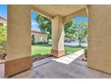 Covered entryway with arched columns and views of the backyard at 1131 Evening Ridge St, Henderson, NV 89052