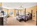 Large main bedroom with a four-poster bed and access to a deck at 173 Kirkton St, Henderson, NV 89012