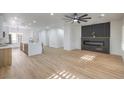 Bright living room with a modern fireplace and light wood flooring at 2183 Cumberland Hill Dr, Henderson, NV 89052