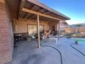 Backyard patio with covered seating and pool access at 6249 W Gowan Rd, Las Vegas, NV 89108