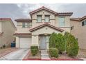 Two-story house with red tile roof, landscaping, and a gray door at 689 Iron Bridge St, Las Vegas, NV 89178