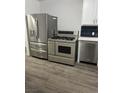 Stainless steel appliances and luxury vinyl plank flooring in the kitchen at 1424 Wengert Ave, Las Vegas, NV 89104