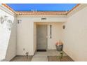 Front entrance with decorative metal door and potted plants at 6020 Theatrical Rd, North Las Vegas, NV 89031