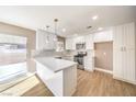 Updated kitchen boasts white cabinets, quartz countertops, and a breakfast bar at , Henderson, NV 89002