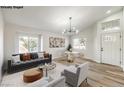 Virtually staged living room with dining area and hardwood floors at 1941 Toscanini Way, North Las Vegas, NV 89032