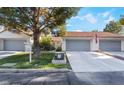 Neatly landscaped yard with double-car garage and inviting facade at 2253 Van Gogh Dr, Henderson, NV 89074