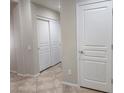 A hallway with white doors and tiled floors at 2652 Rue Marquette Ave, Henderson, NV 89044