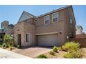 Two-story house with attached garage and desert landscaping at 2661 Skylark Trail St, Henderson, NV 89044