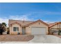 Front view of a single-story house with a two-car garage at 5217 Yellow Dawn Ct, Las Vegas, NV 89130