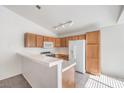 Kitchen with light wood cabinets, tile flooring, and a breakfast bar at 1183 Winnipeg Ct, Henderson, NV 89002