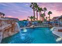 Inviting pool with a waterfall feature, surrounded by lush landscaping at 233 Molly Ct, Las Vegas, NV 89183