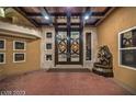 Double doors entry with decorative fountain and high ceilings at 4927 Spanish Heights Dr, Las Vegas, NV 89148