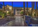 Grand entrance to a beautiful home with mature landscaping at 4927 Spanish Heights Dr, Las Vegas, NV 89148