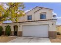 Two-story house with a white garage door and fall leaves at 725 Moonlight Mesa Dr, Henderson, NV 89011