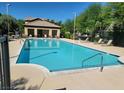 Community swimming pool with lounge chairs and shaded seating area at 8324 W Charleston Blvd # 2033, Las Vegas, NV 89117