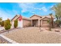 Single story house with a two-car garage and desert landscaping at 4318 Red Blanket Rd, North Las Vegas, NV 89032