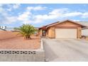 Front view of a single-story house with a two-car garage at 4765 Marlboro Ct, Las Vegas, NV 89147