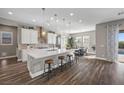 Spacious kitchen featuring an island, white cabinets, and hardwood floors at 5523 Taylor Rose Ave, Las Vegas, NV 89139