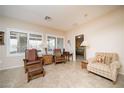 Relaxing sitting area with comfortable armchairs and a view of the backyard at 7345 Shelduck St, North Las Vegas, NV 89084