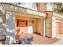 Peach colored front door with a tiled entryway at 7624 Delaware Bay Dr, Las Vegas, NV 89128