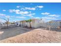 Tan single story home with a spacious yard and gated entrance at 10 Nevada Way, Henderson, NV 89015