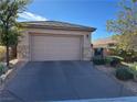 Single story home with attached garage and drought-tolerant landscaping at 2675 Lochleven Way, Henderson, NV 89044