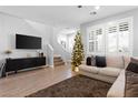 Spacious living room featuring a comfortable sectional sofa and a modern TV at 3562 Pontesei Ln, Henderson, NV 89044