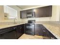 Modern kitchen with dark cabinets and granite countertops at 5324 Swenson St # 60, Las Vegas, NV 89119