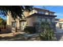 Two-story house with stone accents and a three-car garage at 9151 Edgeworth Pl, Las Vegas, NV 89123