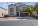 Two story home with a two car garage and landscaping at 7717 Rainbow Cove Dr, Las Vegas, NV 89131