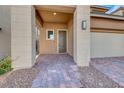 Front entry with covered porch and brick walkway at 12397 Foxtail Run Ave, Las Vegas, NV 89138