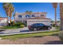 Two-story house with a three-car garage and manicured lawn at 1819 Wild Indigo Ct, Las Vegas, NV 89123