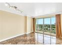 Living area with marble floors and access to a balcony with city views at 322 Karen Ave # 903, Las Vegas, NV 89109