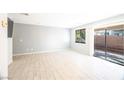 Spacious living room featuring tile floors and sliding glass doors at 753 Spotted Eagle St, Henderson, NV 89015