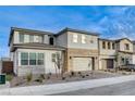 Two-story home with stone and wood accents, two-car garage, and landscaped front yard at 9002 Shifting Skye St, Las Vegas, NV 89166