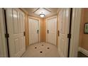 Residential entryway with three white doors and a patterned floor at 145 Harmon Ave # 704, Las Vegas, NV 89109