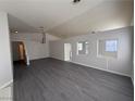 Spacious living room with gray vinyl flooring and a chandelier at 5236 Zebra Ct, North Las Vegas, NV 89031