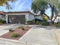 Single story home with two car garage and nicely landscaped front yard at 4545 Madreperla St, Las Vegas, NV 89121